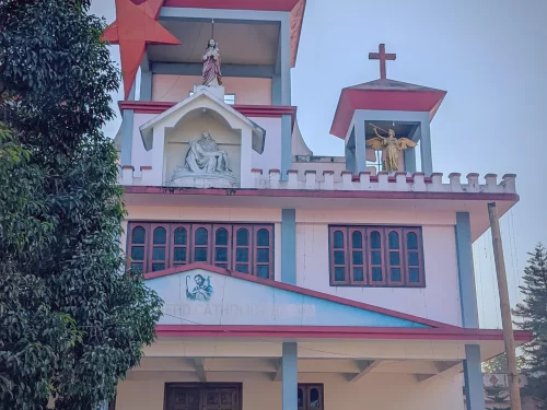 Good Shepherd Catholic Church in Arunachal Pradesh with cross tower and religious statues