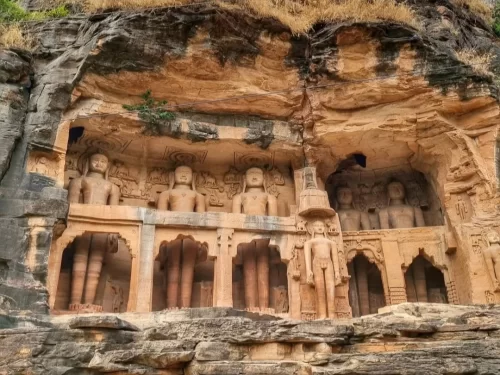  Rock-cut Jain statues at Gopachal Jain Parvat in Gwalior carved into sandstone cliffs, a historic pilgrimage site featured in Madhya Pradesh tour packages
