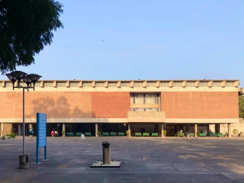 Modern facade of Government Museum & Art Gallery at Chandigarh during sunny day, featuring brick building, street lamps, trees, benches, perfect heritage Chandigarh tour package.