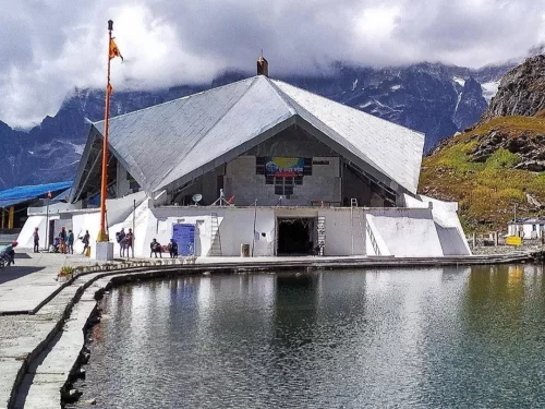 Gurdwara Hemkund Sahib in Ghangharia, Uttarakhand set beside the glacial lake with snow-clad Himalayan peaks in the backdrop, a revered Sikh pilgrimage site included in Uttarakhand tour packages
