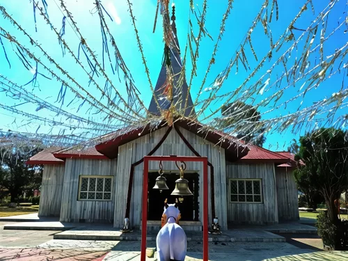 Haidakhan Babaji Temple in Ranikhet, Uttarakhand with prayer flags and bells adorning the wooden shrine, a peaceful spiritual retreat featured in Uttarakhand tour packages