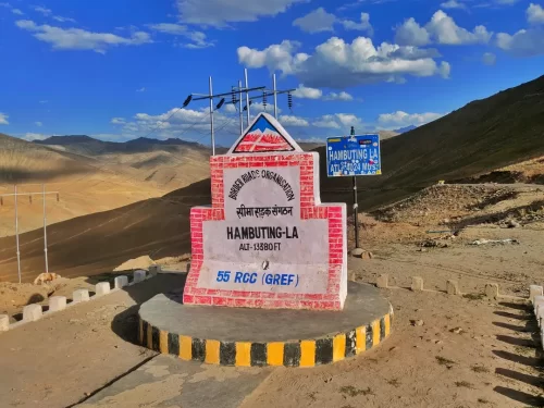 Hamboting La monument at BRO Ladakh during partly cloudy day, featuring brick arch altitude marker mountains terrain, perfect adventure Ladakh tour package.