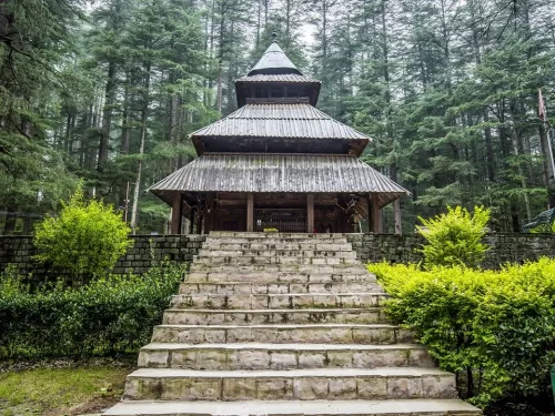 Hidimba Temple at Manali Himachal Pradesh during misty weather, featuring tiered pagoda roof surrounded by deodar trees, ancient sanctuary Incredible India experience Himachal Pradesh tour package.