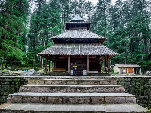 Hidimba Temple at Manali Himali Pradesh during misty weather, featuring multi-tiered wooden pagoda deodar forest, ancient sanctuary Incredible India experience Himachal Pradesh tour package.