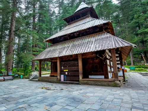 Hidimba Temple at Manali Himachal Pradesh during misty weather, featuring ancient wooden pagoda tower deodar forests, perfect spiritual experience Himachal Pradesh tour package.