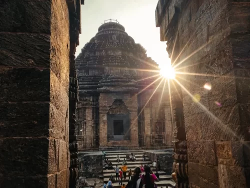 Jagamohana at Konark Sun Temple Odisha during sunset, featuring stone shikhara dome, carved pillars, crowds, misty rays, perfect heritage experience Odisha tour package. 