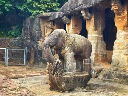 Udayagiri Caves Odisha Ganesha Gumpha elephant statue trunk lotus foliage rock-cut pillars entrance, perfect Bhubaneswar Jain heritage tour package.