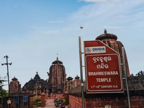 Brahmeswara Temple Bhubaneswar Odisha 11th century Kalinga shikhara signboard, red sandstone towers ASI board Somavamsi ruins, perfect Bhubaneswar temple trail package.
