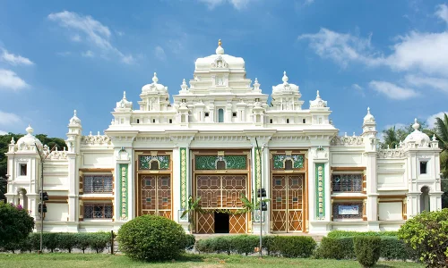 Melody World Wax Museum in Mysuru during daylight, featuring grand heritage-style architecture and lush gardens, perfect family experience, Karnataka tour packages.