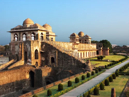 Jahaz Mahal at Mandu under golden hour glow, featuring tiered domes grand staircase and manicured gardens, perfect heritage experience with Madhya Pradesh tour packages.