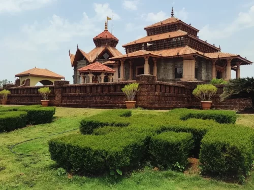 Jai Vinayak Mandir in Maharashtra showcasing traditional temple architecture with tiled roofs, stone walls and landscaped gardens, a peaceful spiritual attraction included in Maharashtra tour packages
