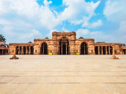 Majestic arches at Jama Masjid Ahmedabad during daylight, featuring domes and colonnades, perfect cultural Gujarat tour package.