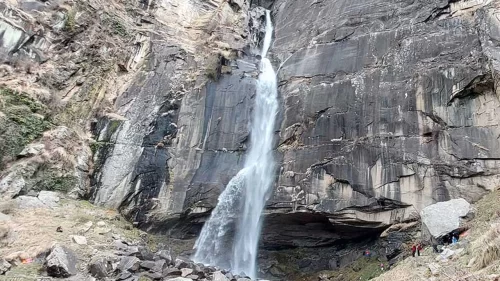 Jogini Waterfall at Manali Himachal Pradesh during misty day, featuring cascading water from rocky cliffs amid greenery, perfect adventure experience Himachal Pradesh tour package.