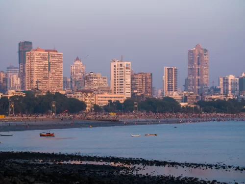 Juhu Beach Mumbai golden hour skyline crowd fishing boats Arabian Sea palm trees, perfect Mumbai beach sunset street food celebrity spotting package. 
