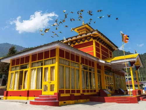 Kalachakra Gompa vibrant Buddhist monastery with colorful architecture and fluttering prayer flags in Arunachal Pradesh Package.