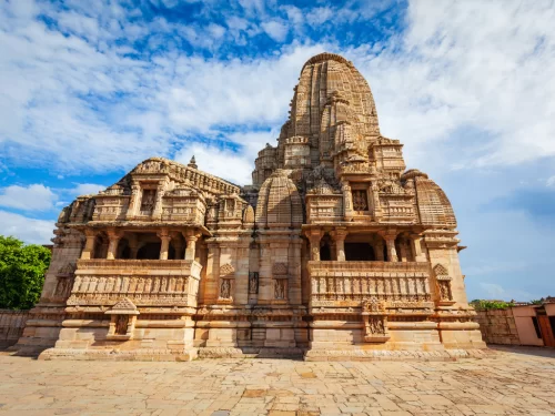 Kalika Mata Temple shikhara at Chittorgarh Fort in Rajasthan during sunny day, featuring intricate carvings and blue sky, perfect Rajasthan tour package.