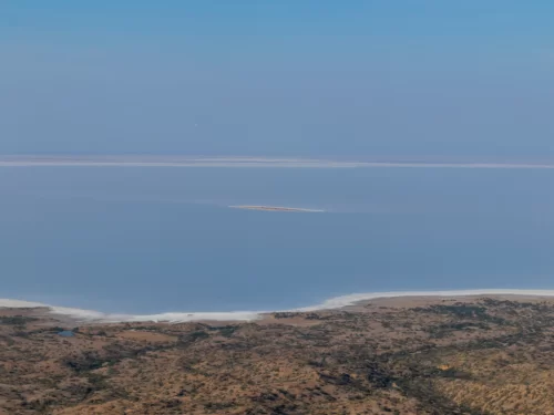 Kalo Dungar panoramic view of Great Rann of Kutch during clear day, featuring vast salt desert expanse, arid foreground hills and distant horizon, perfect adventure experience with Gujarat tour packages.