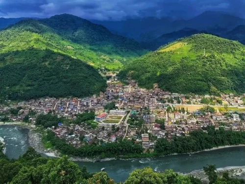 Kameng River flowing gracefully along the scenic valley town surrounded by lush green hills in Arunachal Pradesh Package.