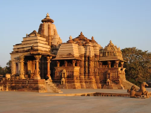 Kandariya Mahadeva Temple Khajuraho golden hour side view Western Group UNESCO site, tallest Nagara shikhara 31m 84 urushringas Shiva shrine intricate carvings Chandela Vidyadhara 1025-1050 CE, ideal Madhya Pradesh heritage tour package.