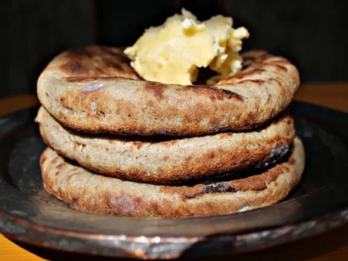Khambir is a traditional Ladakhi flatbread thick, soft, and slightly crisp outside typically made from whole wheat flour and naturally fermented, often served warm with butter, chutney, or local curries.