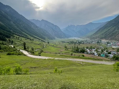 Khandiyal Top Gurez Valley panoramic viewpoint overlooking lush meadows, village landscape and Himalayan mountains in Kashmir