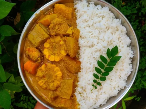 Sunset at Goa beach during evening, featuring palm trees and boats, perfect romantic experience Goa tour package.