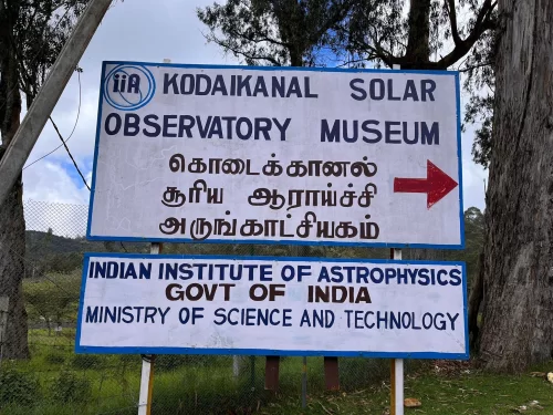 Kodaikanal Solar Observatory Museum entrance signboard showing directions and Indian Institute of Astrophysics details, ideal educational stop in Tamil Nadu tour package