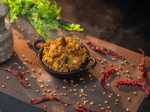 Houseboat at Alleppey backwaters during sunset, featuring palm trees and calm lagoons, romantic Kerala tour package.
