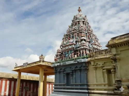 Kothandaramaswamy Temple in Dhanushkodi featuring the white stone structure, turquoise sea, and idols of Rama and Vibhishana.