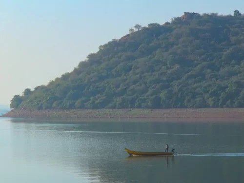 Krishna River Ghat serene riverside view with hills in Andhra Pradesh tour packages.