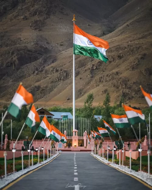 Indian national flag at Drass War Memorial in Ladakh with mountain backdrop, a historic landmark included in Ladakh tour packages
