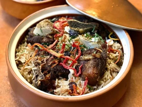 Authentic Ladakhi Pulao, a fragrant rice dish cooked with tender meat, dried fruits, and Himalayan spices, served in traditional style.