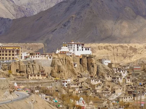 Lamayuru Monastery Ladakh iconic moonland panorama with white gompa perched on eroded cliffs amid rugged Himalayan peaks and village, top attraction on Leh Kargil highway in Ladakh tour packages
