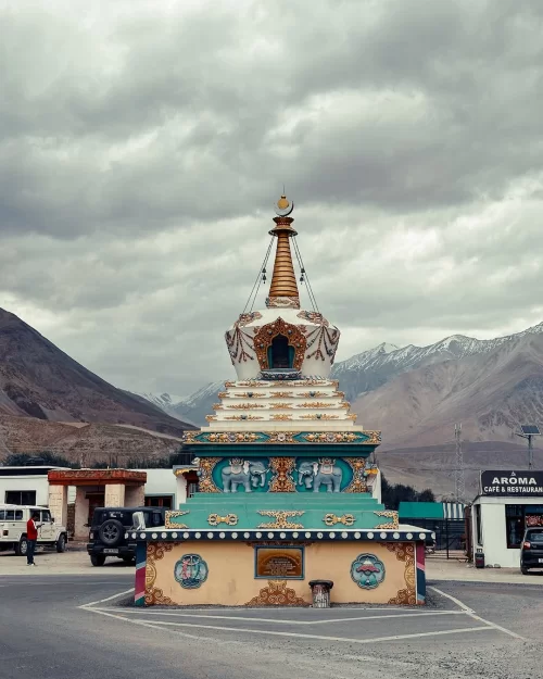 Colorful Buddhist stupa near Diskit in Nubra Valley Ladakh with mountain backdrop, a cultural landmark featured in Ladakh tour packages