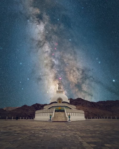 Shanti Stupa in Leh Ladakh under a spectacular Milky Way night sky, a peaceful landmark featured in Ladakh tour packages