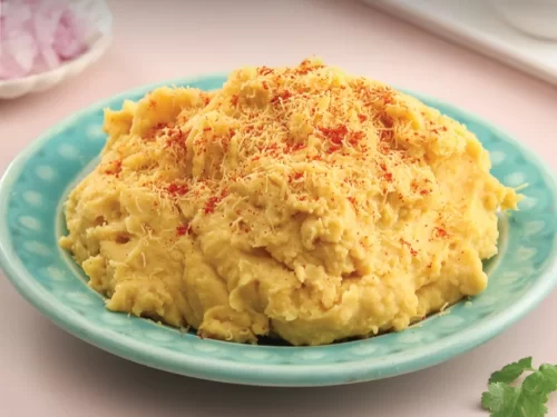 Surat Locho, a soft and fluffy steamed gram flour dish topped with sev and spices, popular Gujarati street food delight.