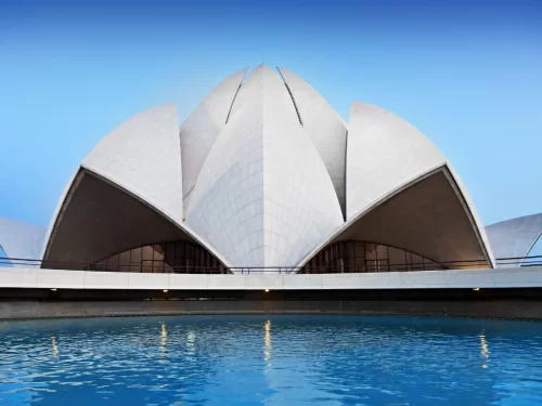 Lotus Temple, New Delhi – elegant white marble lotus petals rising above the tranquil blue reflecting pool, iconic Bahá’í House of Worship and serene highlight of Delhi city tour packages.