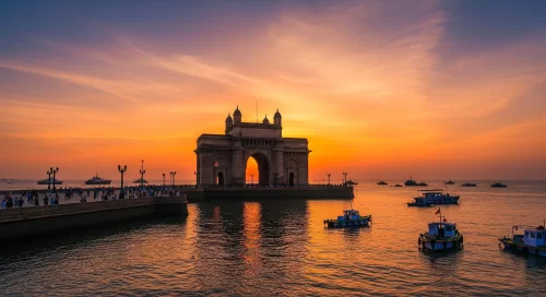 Gateway of India Mumbai at sunset, featuring boats and reflections, romantic Maharashtra tour package.