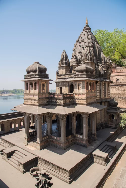 Maheshwar Temple on the banks of Narmada River in Madhya Pradesh featuring elegant Maratha architecture and riverside ghats perfect for Maheshwar spiritual tours and Madhya Pradesh heritage travel packages