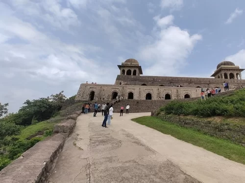 Stone structure of Mandu Archaeological Museum in Mandu, Madhya Pradesh, featuring arched corridors and domed pavilions on a hilltop, a heritage site included in Madhya Pradesh tour packages