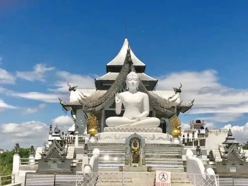 Metta Buddharam Temple Kushinagar, serene Buddhist temple featuring grand white Buddha statue and ornate Thai-style architecture in Uttar Pradesh. 