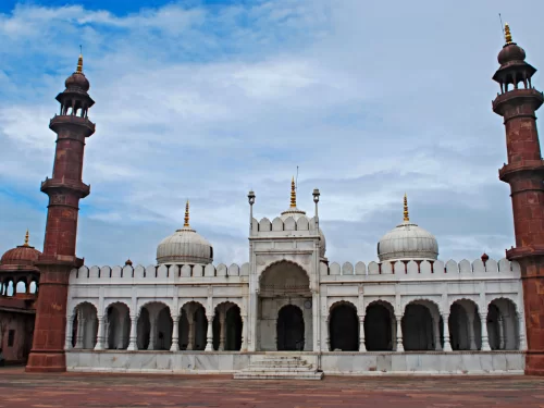 Moti Masjid at Bhopal during partly cloudy day, featuring red minarets white marble arches domes, perfect cultural Madhya Pradesh tour package.