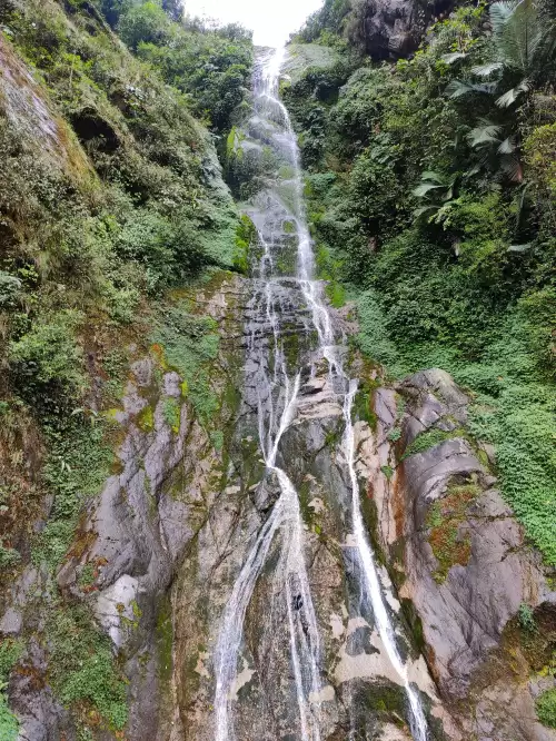 Nichiphula Waterfall in Arunachal Pradesh cascading down rocky cliffs surrounded by lush greenery featured in Arunachal Pradesh tour packages
