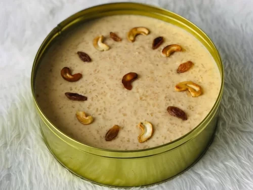 Houseboat at Alleppey backwaters during sunset, featuring palm trees and calm lagoons, romantic Kerala tour package.