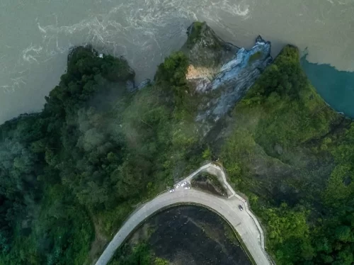 Pasighat View Point stunning aerial view of winding road and lush green hills overlooking the river in Arunachal Pradesh Package.