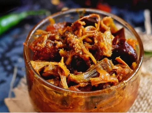 Pika Pila is a spicy Assamese pork pickle made with pork, bamboo shoot, and mustard oil, known for its bold, smoky flavor.