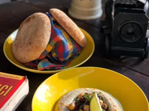 Sunset at Goa beach during evening, featuring palm trees and boats, perfect romantic experience Goa tour package.