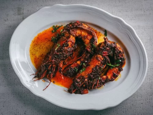 Sunset at Goa beach during evening, featuring palm trees and boats, perfect romantic experience Goa tour package.