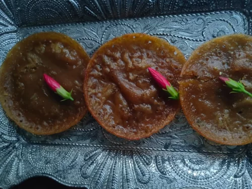 Pukhlein is a traditional Meghalayan sweet made from rice flour and jaggery, deep-fried to a glossy caramel finish with a rich, earthy sweetness.