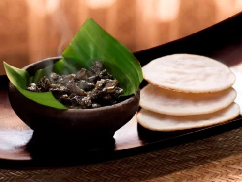 Putharo is a traditional steamed rice cake from Meghalaya, soft and mildly sweet, perfectly paired with flavorful local meat dishes for an authentic tribal feast.
